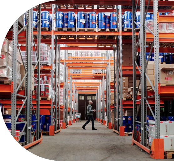 Business owner walking through a stocked warehouse